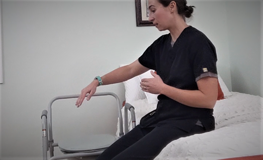 woman sitting on bed next to commode