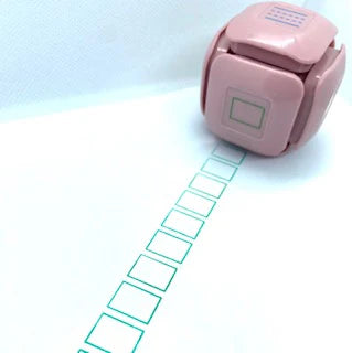 LegiLiner LegiCube Self-Inking Teacher Stamp - Math and Handwriting Lines Multi-Roller Stamp stamping green boxes in white sheet from AskSAMIE