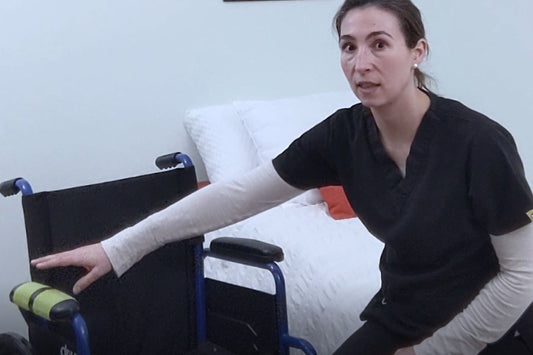 woman sitting on bed next to wheelchair