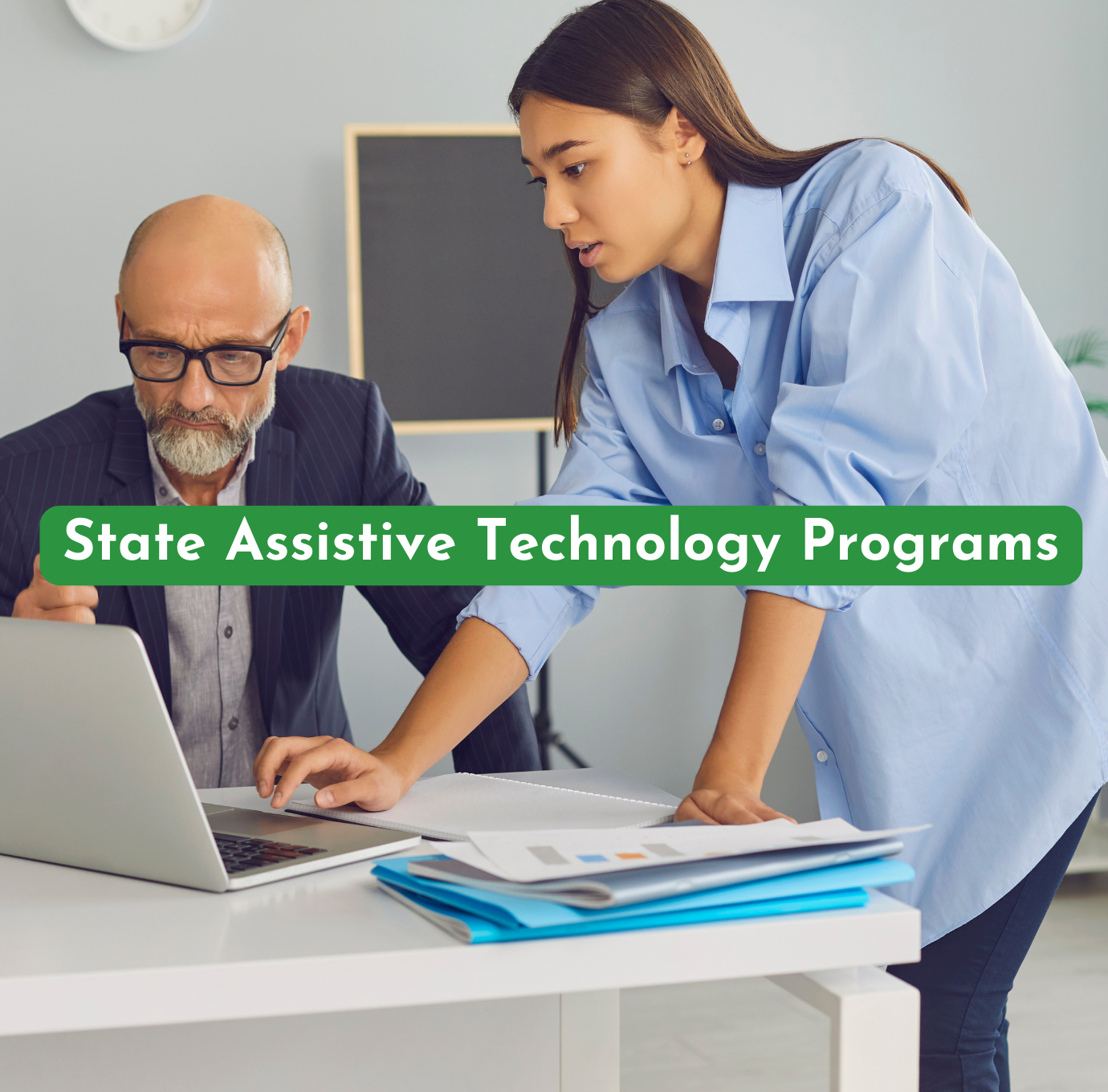 older man being helped ona computer by a younger woman highlighting services at a state assistive technology program referenced by AskSAMIE