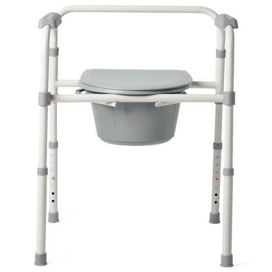 Medline Guardian 3-in-1 folding steel bedside commode in white and gray with padded seat, lid, armrests, and removable gray bucket
