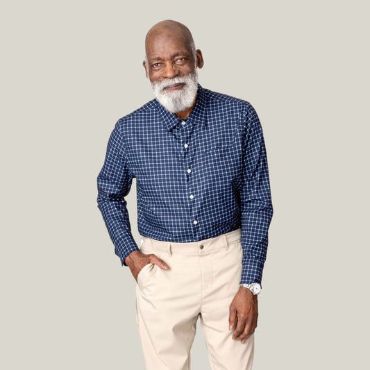 Older man with a white beard wearing the navy check magnetic button-down untucked with khaki pants