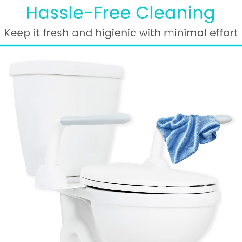 Wiping the toilet safety rail clean with a cloth, the smooth white finish keeps cleaning simple.
