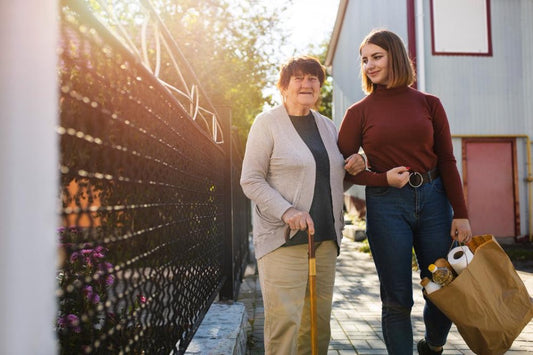 adult daughter arm in arm with her elderly mother. The cover photo for the How to Age in Place blog from AskSAMIE