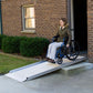 10' Wheelchair Access Ramp installed on steps in front of doorway with elder in wheelchair on the ramp