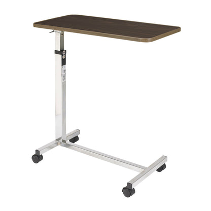 Drive Medical tilt-top overbed table with a 30 by 15 inch walnut laminate top on a chrome H-base with casters, for meals and reading in bed