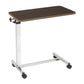 Tilt-top overbed table with the tilt knob under the top and the column at one end, so the base rolls under the bed