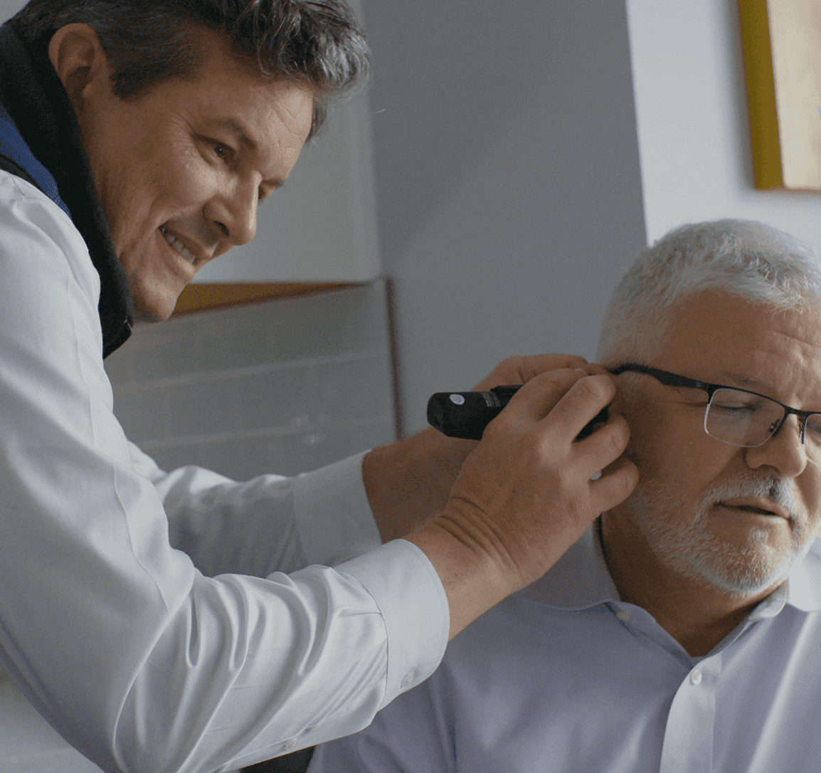 doctor checking patient ear YesHearing at AskSAMIE