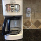 Auto Shut Off Safety Outlet plugged in wall outlet with a coffee maker from AskSAMIE