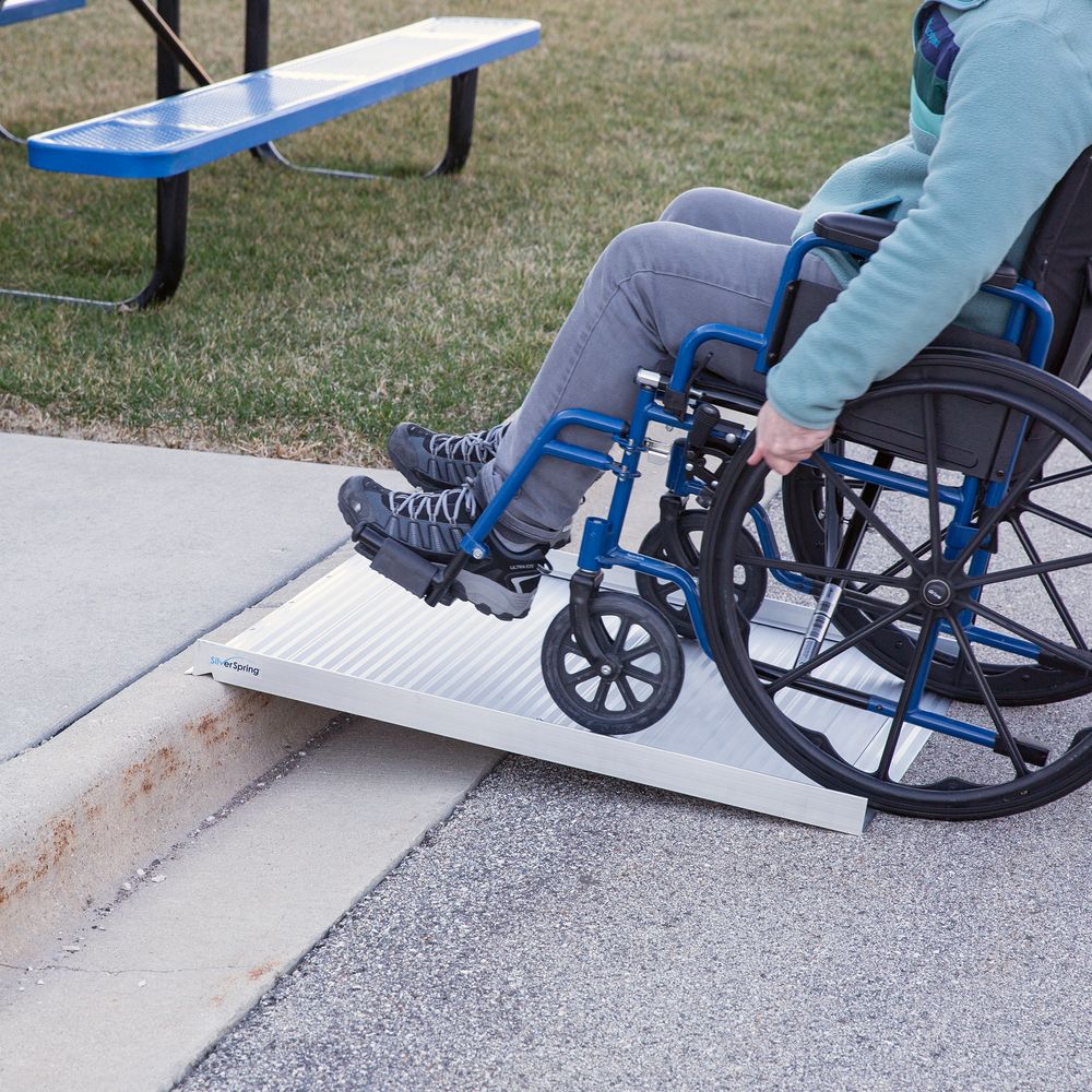 wheelchair going through roll-up ramp |AskSAMIE