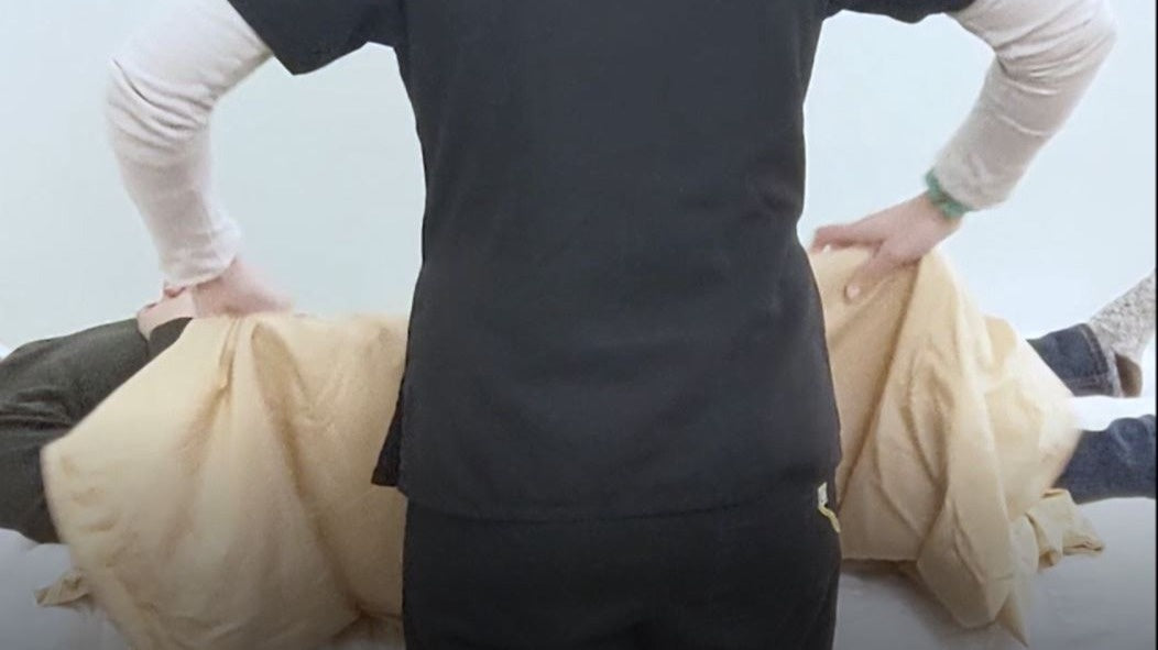 person using draw sheet