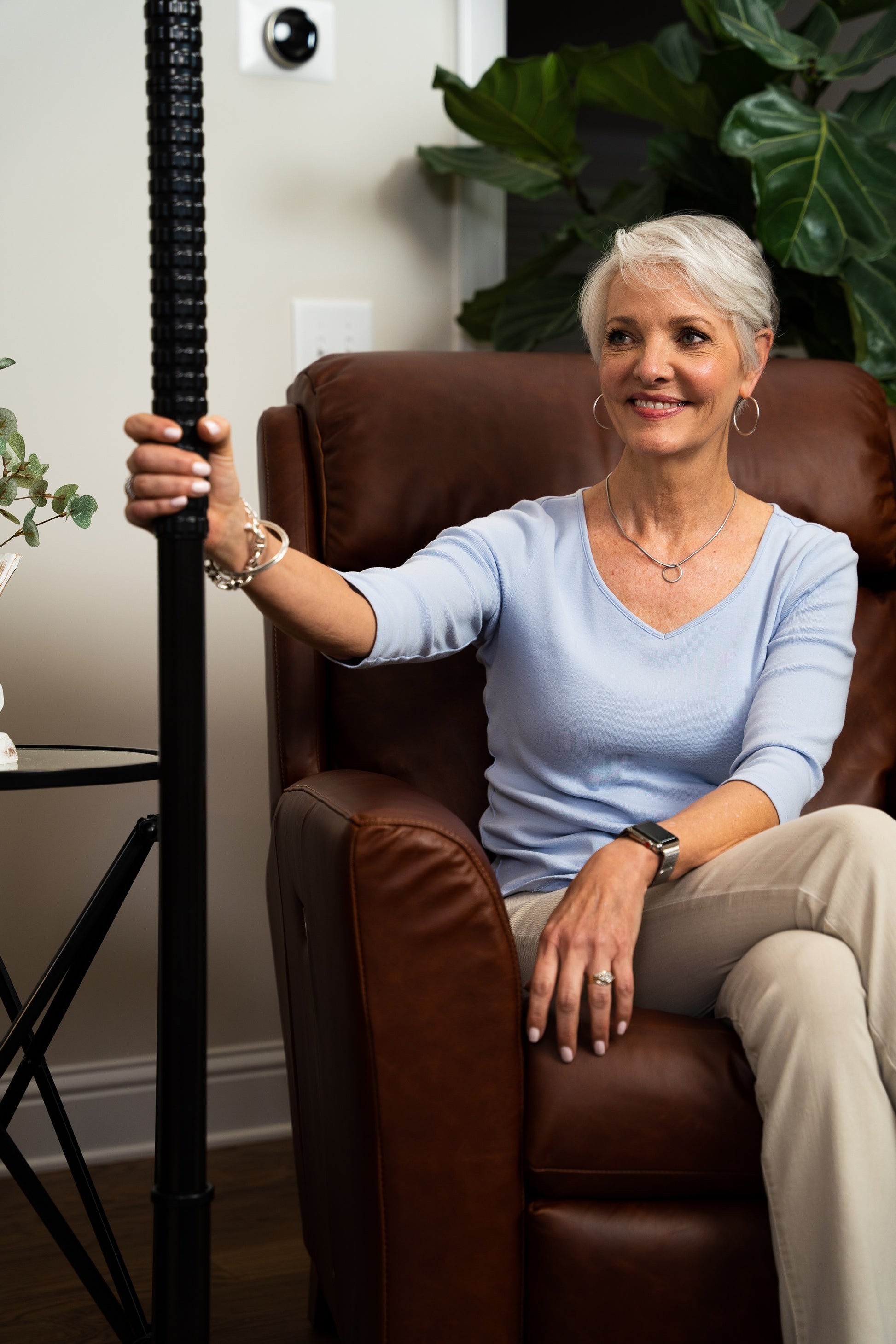 woman sitting by titan transfer pole