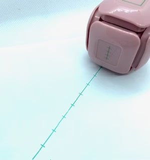 LegiLiner LegiCube Self-Inking Teacher Stamp - Math and Handwriting Lines Multi-Roller Stamp stamping green lines in white sheet from AskSAMIE