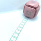 LegiLiner LegiCube Self-Inking Teacher Stamp - Math and Handwriting Lines Multi-Roller Stamp stamping green boxes in white sheet from AskSAMIE