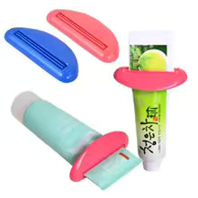 Toothpaste squeezer slid onto a tube and pushed upward with an open hand, no gripping or pinching required