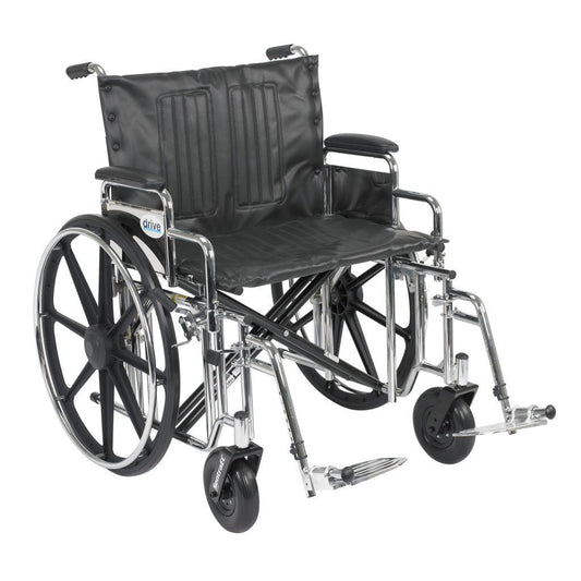 Bariatric manual wheelchair with a wide black seat, detachable padded desk arms, and swing-away footrests, rated to 500 lb.