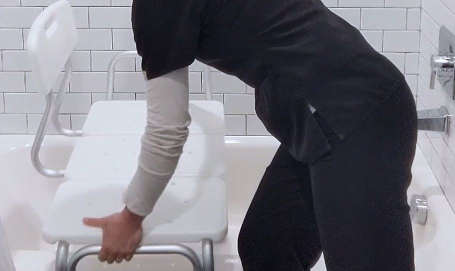 woman using tub transfer bench