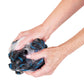 Hands lather the mesh loofah replacement sponge with soap, showing the textured mesh used to gently exfoliate skin in the shower