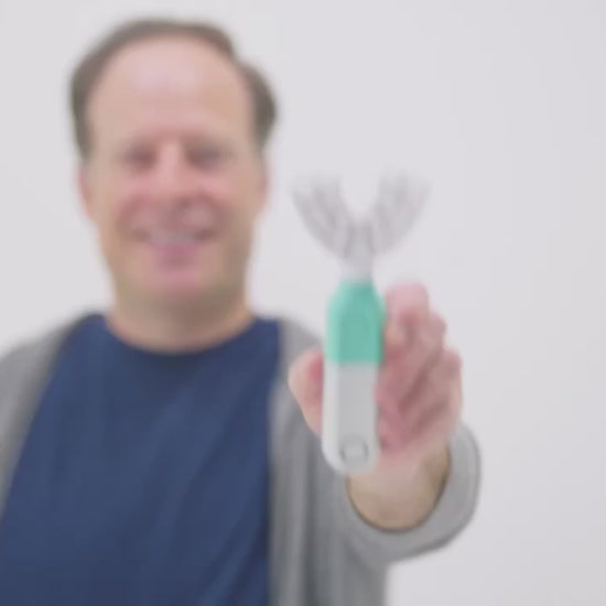 Demonstration of the SymplBrush automatic toothbrush cleaning a full arch of teeth in one 30 second guided cycle, with no brushing motion required.