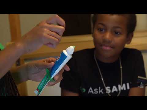 Occupational therapist Dr. Brandy Archie demonstrates how a toothpaste squeezer dispenses paste with an open hand instead of a pinch grip