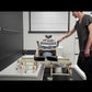 ShowerBuddy TubBuddy Tilt overview showing the reclining chair gliding from the toilet over a bridge into a standard bathtub.