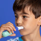 A young boy brushing independently with SymplBrush Jr., holding the handle with a full fist instead of a pencil grip.