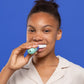 A girl cleaning her teeth with SymplBrush Jr. in a single 30 second guided cycle instead of a two minute manual routine.