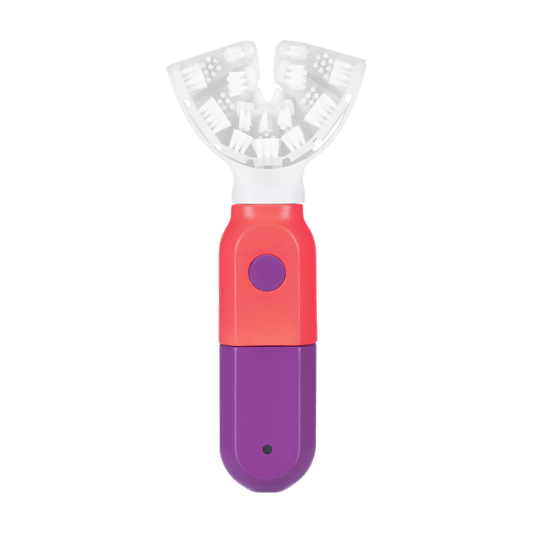 SymplBrush Jr. automatic toothbrush in Coral and Purple, showing the U shaped bristle cradle that cleans a child's whole arch of teeth at once.