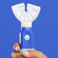 A child's hand holding the Blue and Aqua SymplBrush Jr. by its wide barrel handle, which needs no fine motor control to grip.