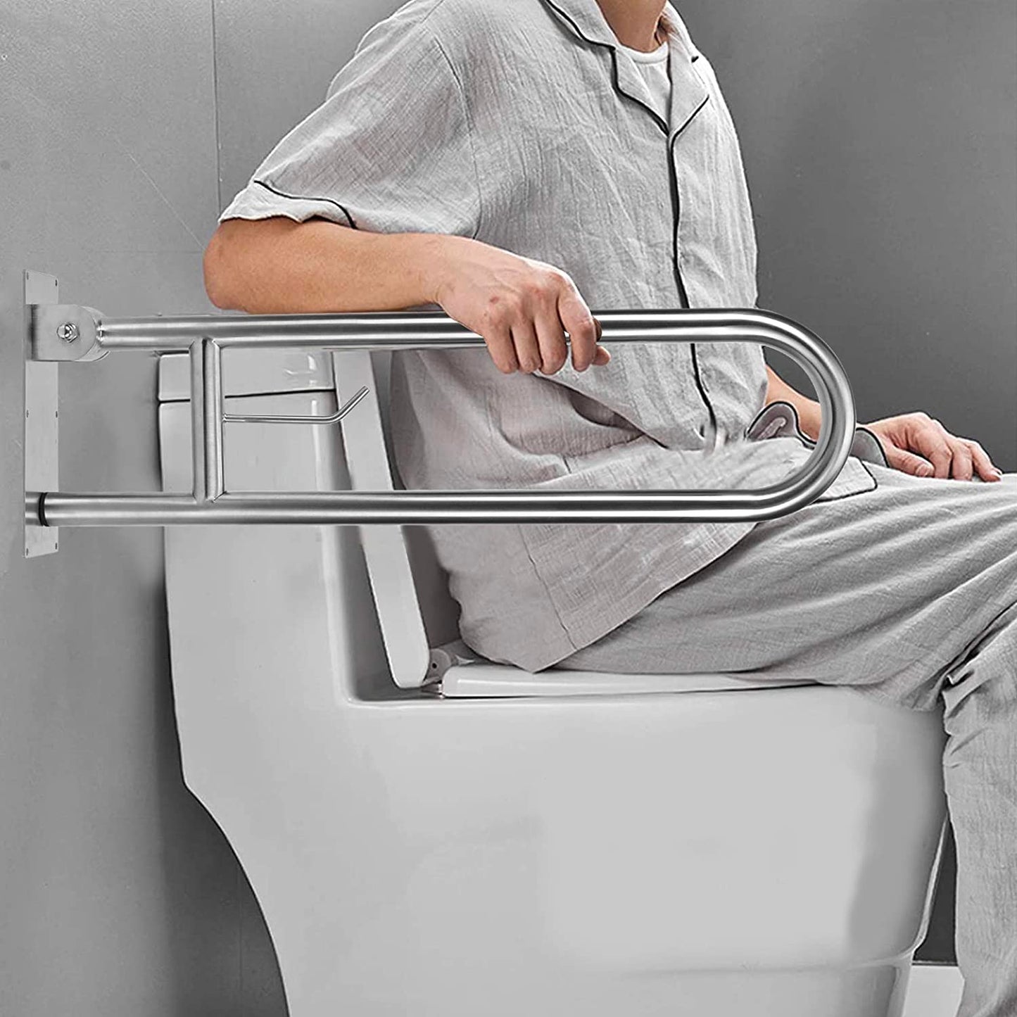 silver 30" flip up grab bar pictured next to a toilet