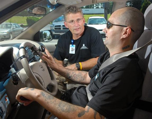 man in car with driving instructor